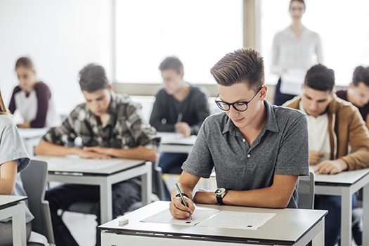 Group of high school students taking a test in their classroom